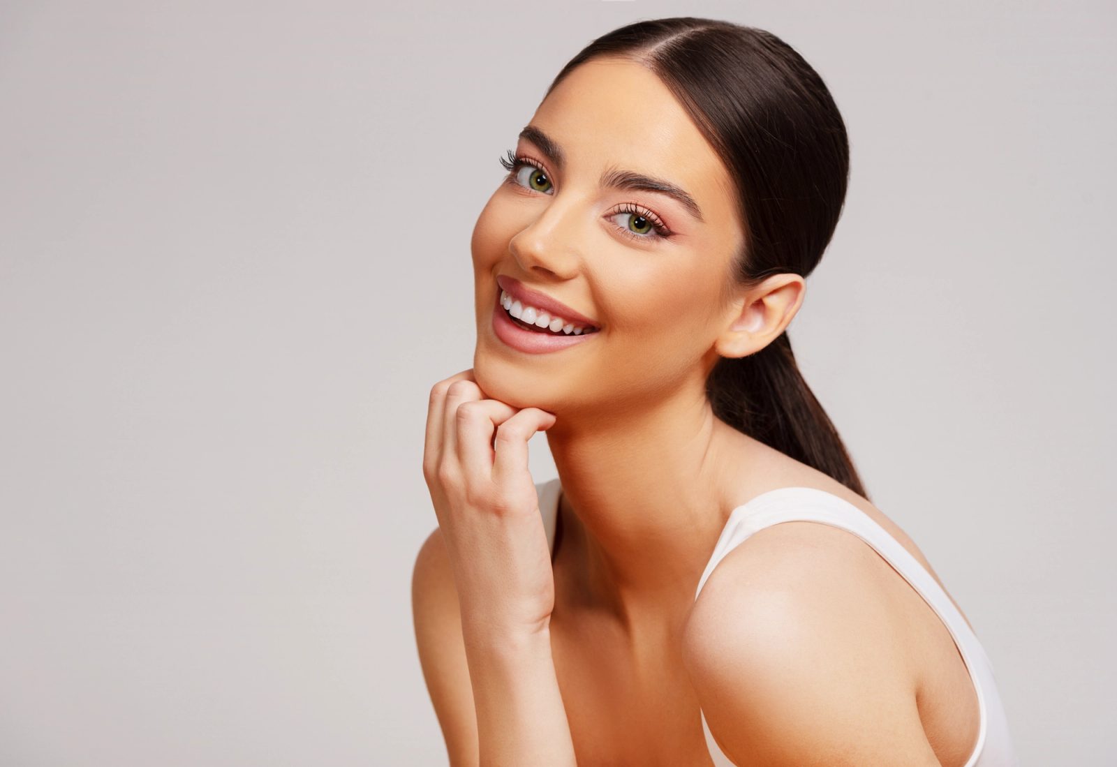 Patient smiling with her hand resting near her chin
