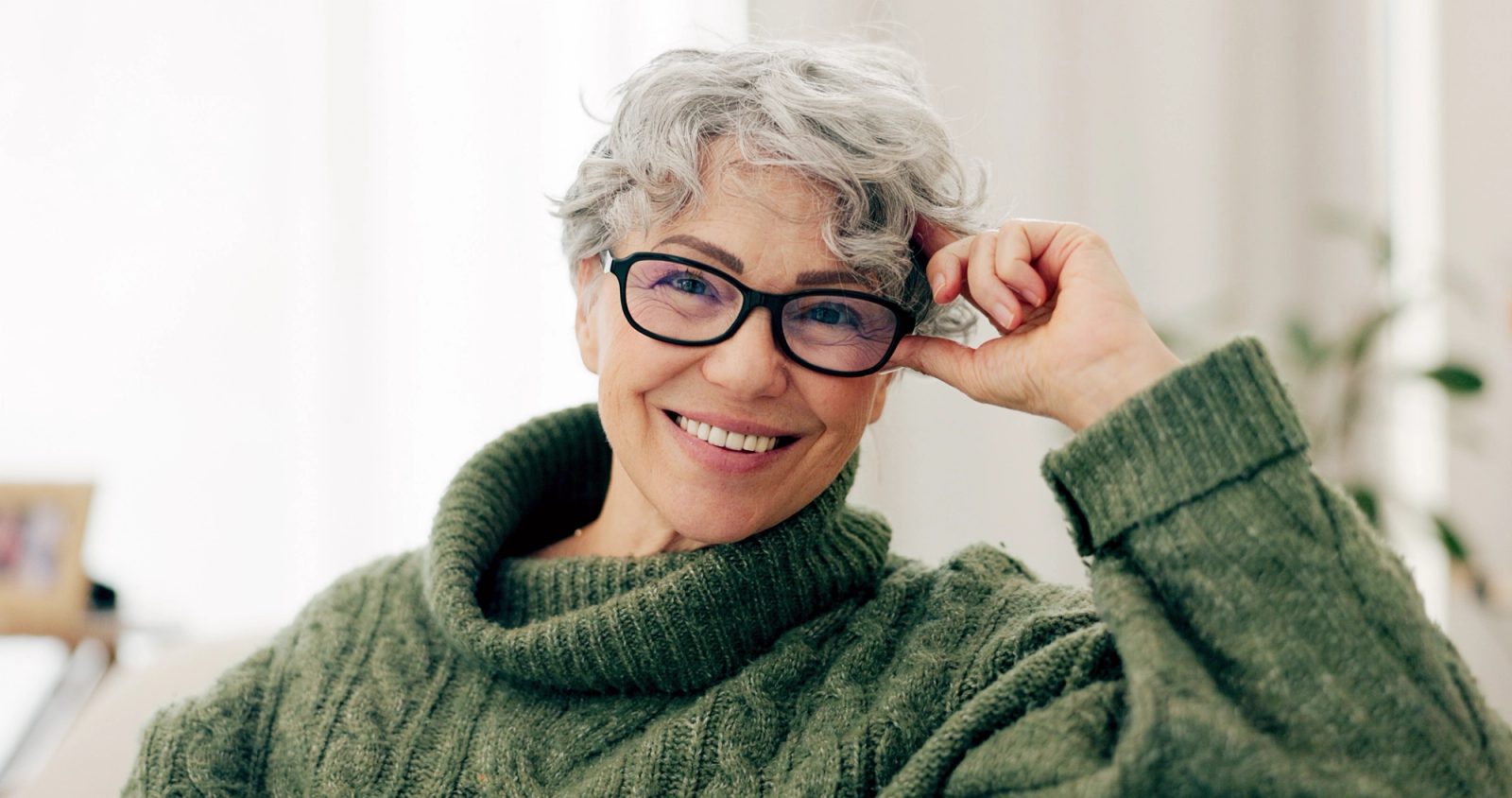 Patient smiling with her hand resting near her chin